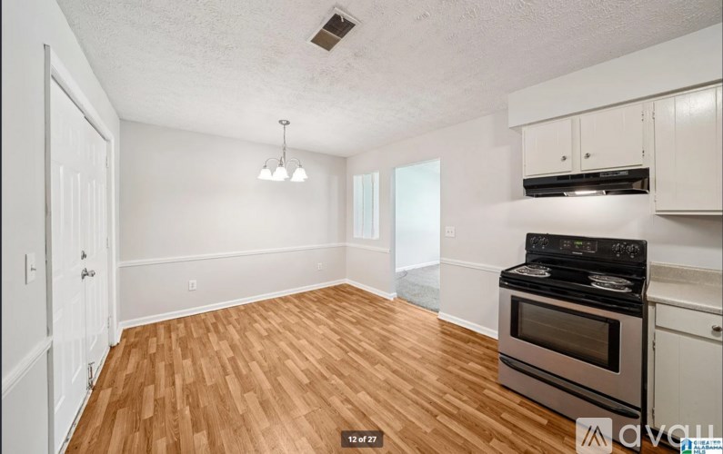 A kitchen with a stove and cabinets.