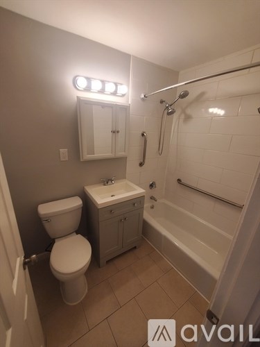 A white toilet sits next to a sink in a small bathroom.