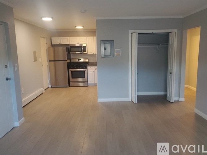 A kitchen with a refrigerator, oven, and microwave.