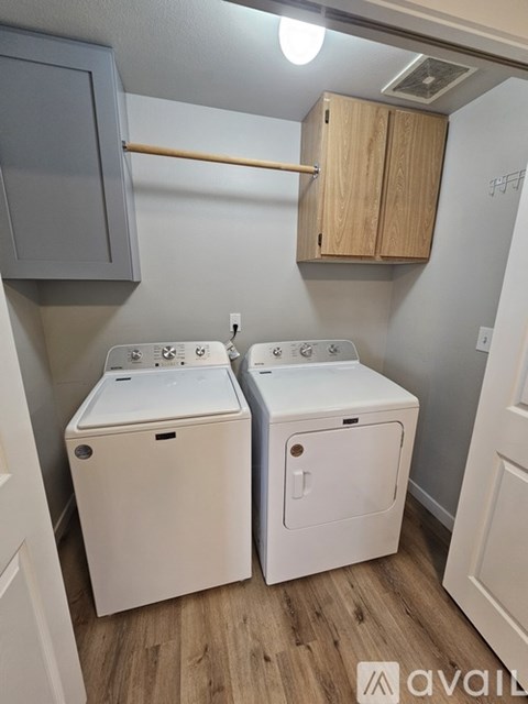 A small laundry room with a washer and dryer.