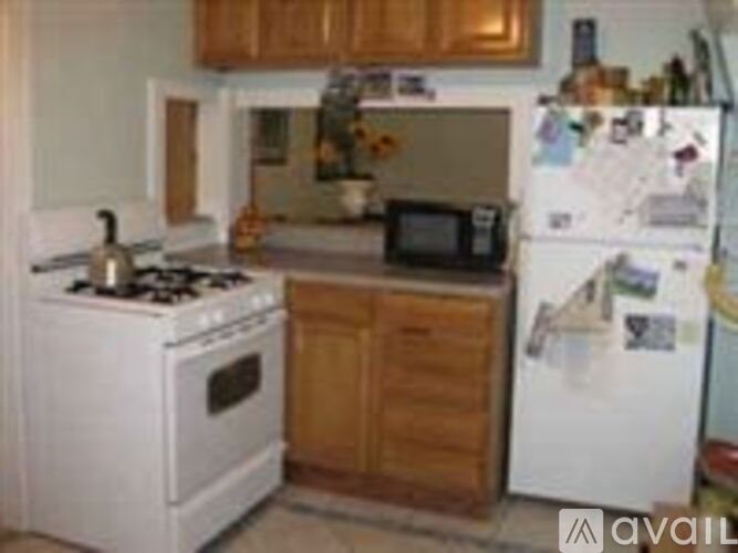 A white stove and refrigerator in a kitchen.