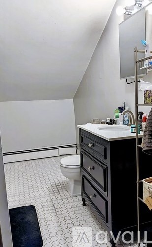 A white sink with a vase of flowers on top of it.
