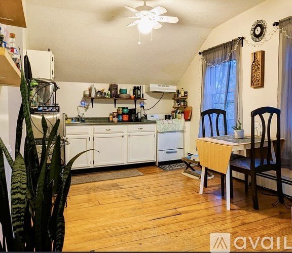 A bathroom with a white tub and a shower curtain.