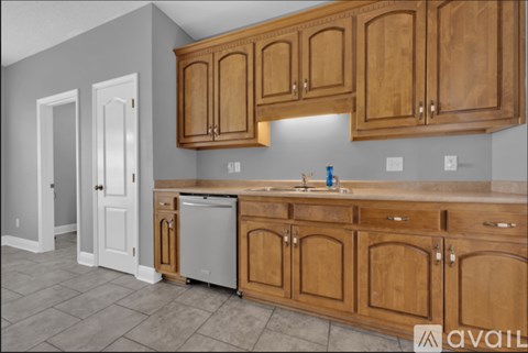 A kitchen with wooden cabinets and a dishwasher.
