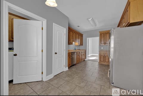 A kitchen with white doors and wooden cabinets.