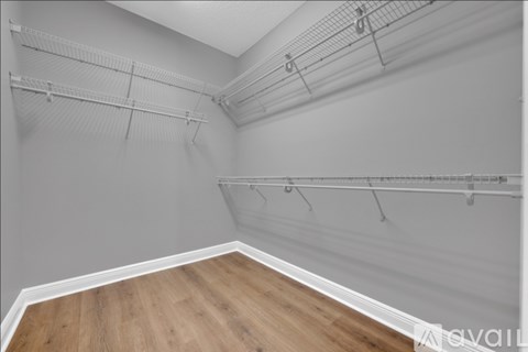 Empty room with white walls and wooden floor.