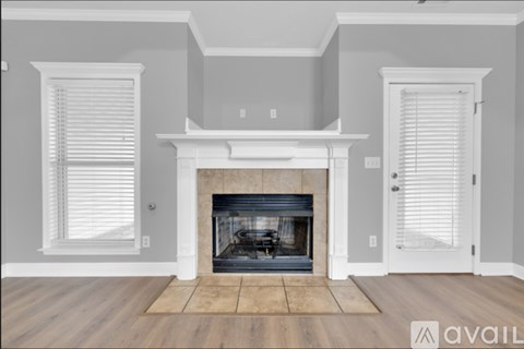 A living room with a fireplace and two doors.