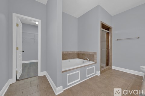 A bathroom with a bathtub and a toilet.