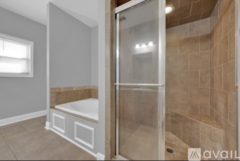 A bathroom with a walk-in shower and a window.