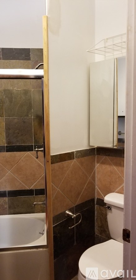 A white toilet sits next to a white sink in a bathroom.