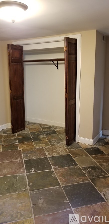 A room with a tile floor and a white closet door.
