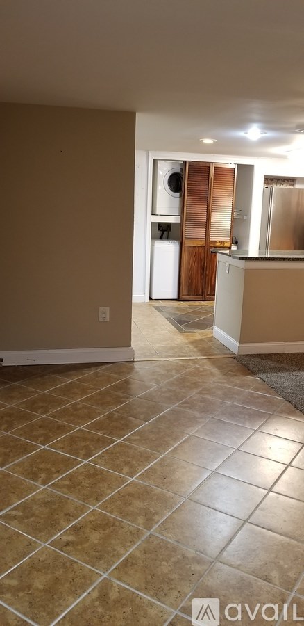A kitchen area with a refrigerator and cabinets.