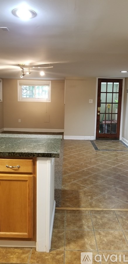 A kitchen with a granite countertop and tile flooring.