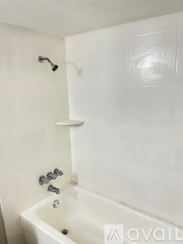 A white bathroom with a tub and shower.