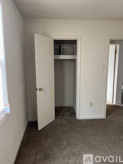 A room with a white door and a window.