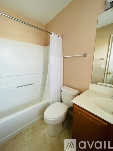 A bathroom with a toilet, sink, and bathtub.