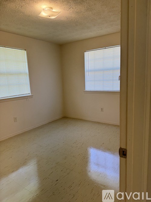 A room with a door, window, and a wall.