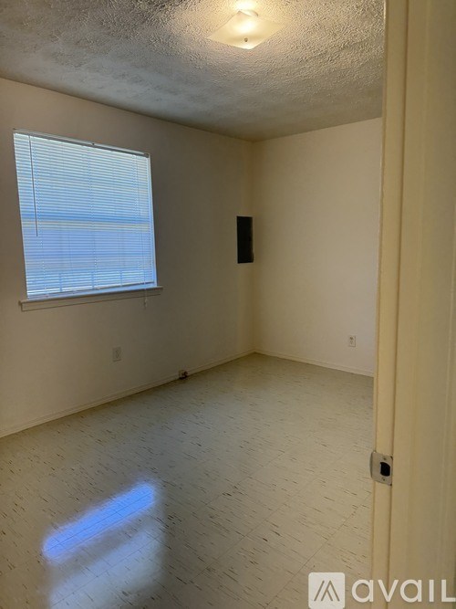 A room with a window and a door.