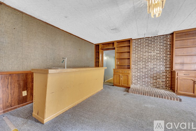 A room with a reception desk and a brick wall.