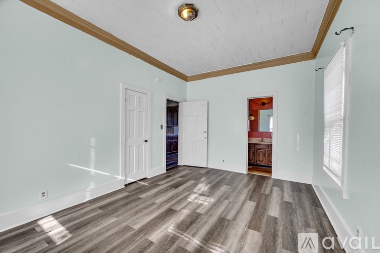 A room with wooden floors and white walls.