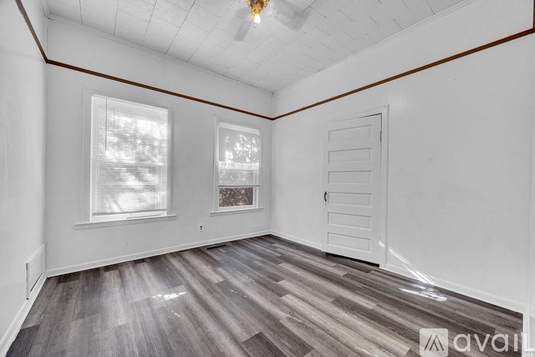 A room with wooden flooring and a ceiling fan.