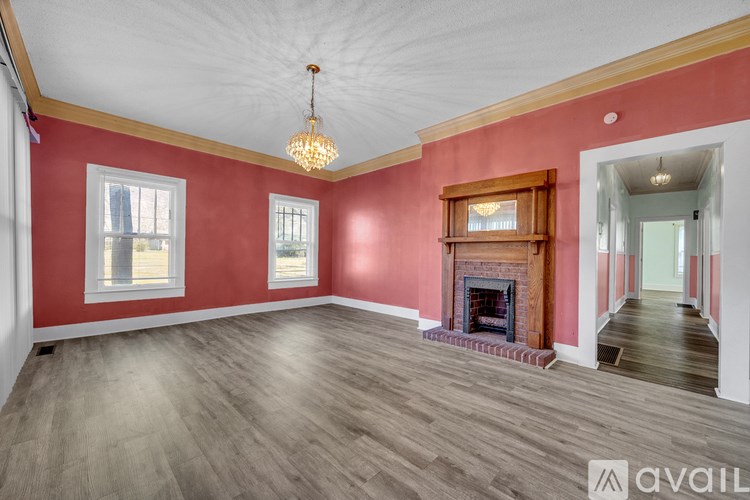 A room with red walls and a fireplace.