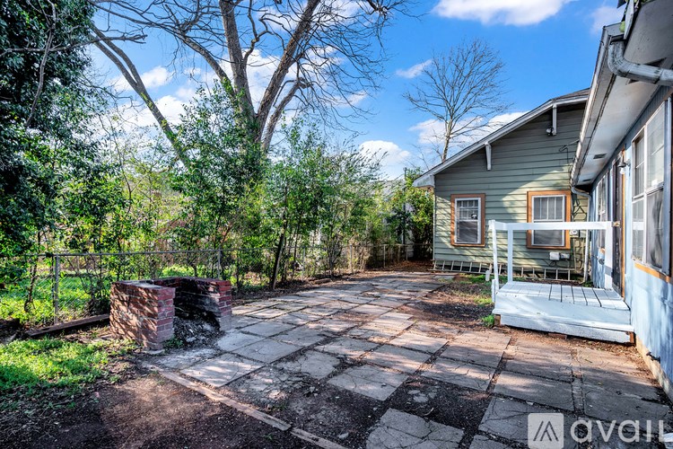 A backyard with a patio and a house.