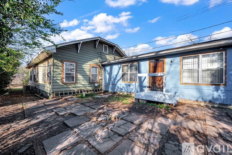 A house with a blue and a green house with a brown door.