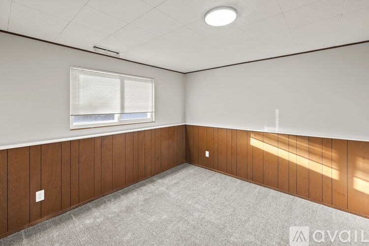A room with wooden paneling and a carpeted floor.