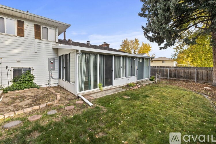 A house with a backyard and a tree.