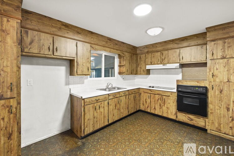 A kitchen with wooden cabinets and a white countertop.