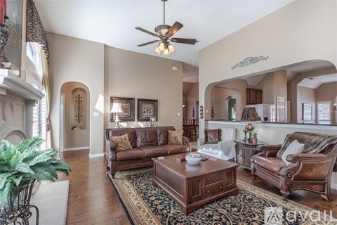 A living room with a brown leather couch and a coffee table.