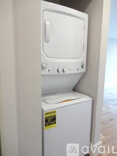 A white dishwasher with a sticker on the front.