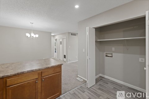 A kitchen area with a counter and cabinets.