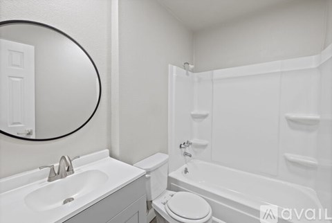 A white bathroom with a sink, toilet, and bathtub.