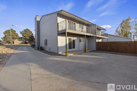 A modern building with a parking lot in front.