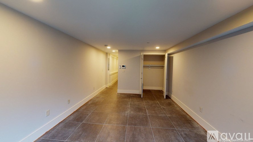 A long hallway with a door at the end.