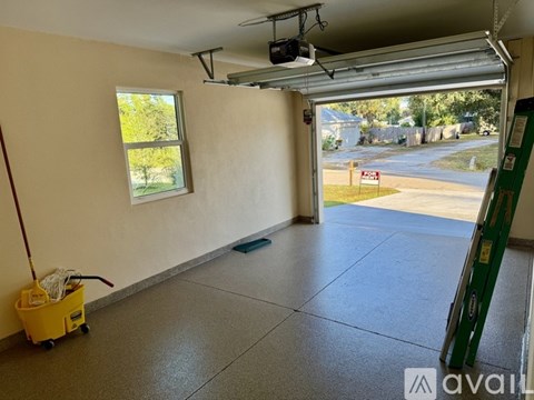 A room with a window and a view of a street outside.