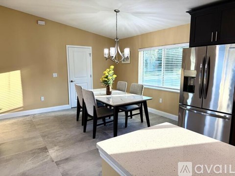 A kitchen with a table and chairs in the middle of the room.