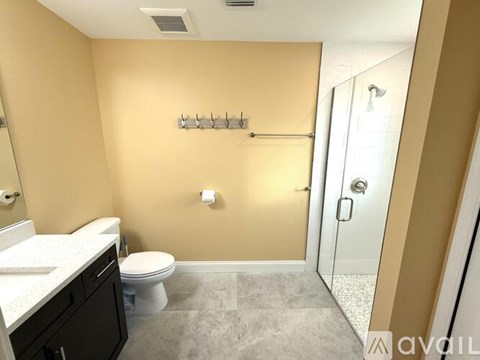 A bathroom with a toilet, sink, and shower.