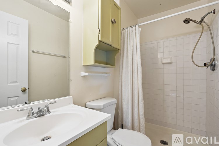 A bathroom with a sink, toilet, and shower.