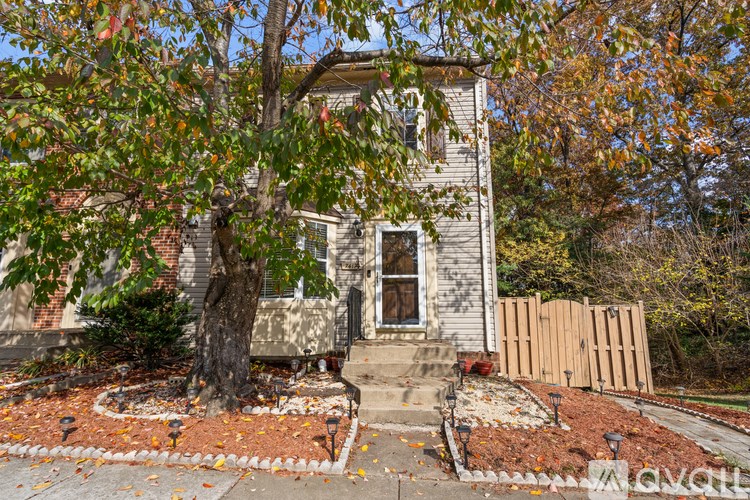 A house with a tree in front of it.