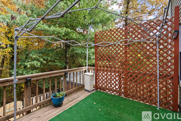 A small deck with a lattice fence and a planter.