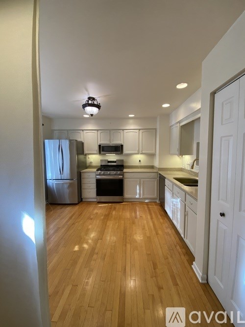 A house with a brown door and a grey siding.