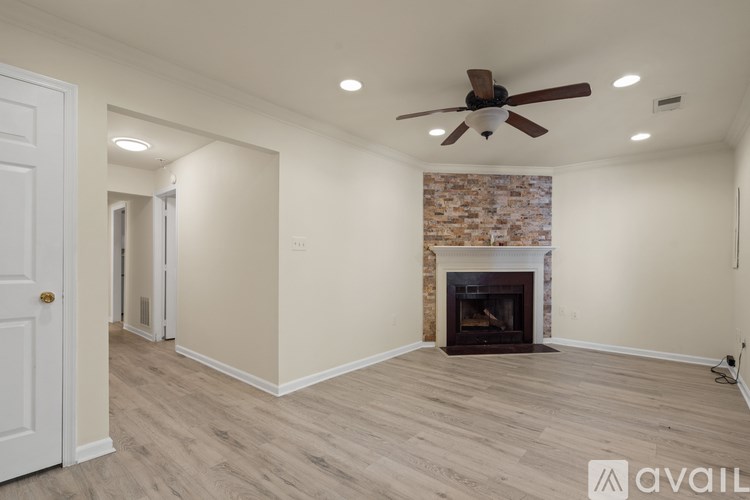A room with a fireplace and a ceiling fan.