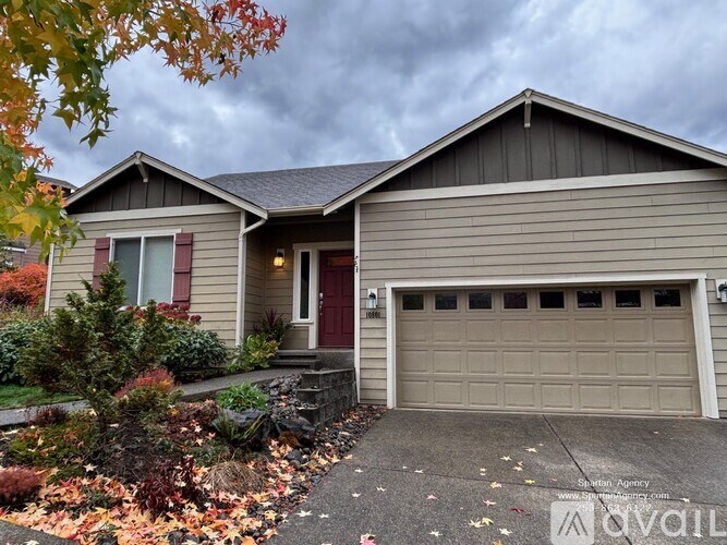 A house with a brown garage door and a red door.
