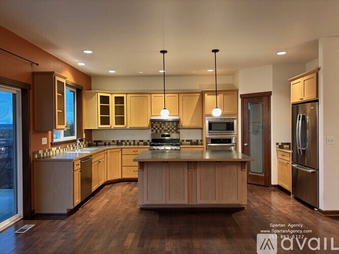 A modern kitchen with wooden cabinets and stainless steel appliances.