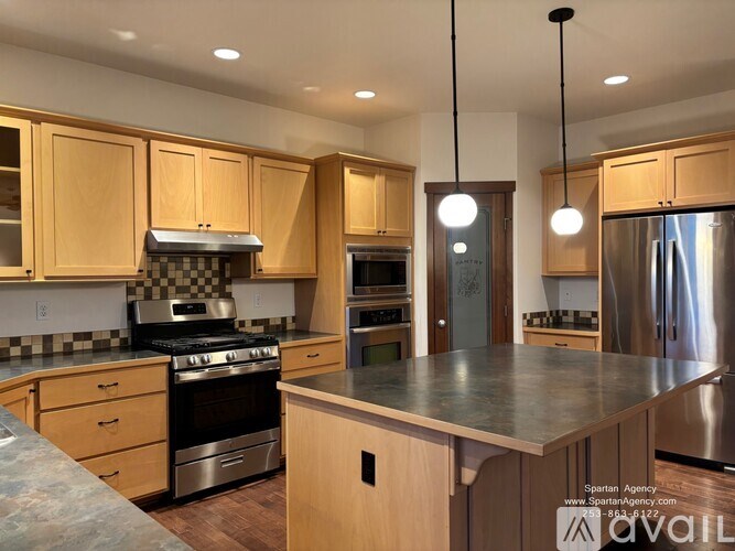 A kitchen with wooden cabinets and a checkered tile backsplash.
