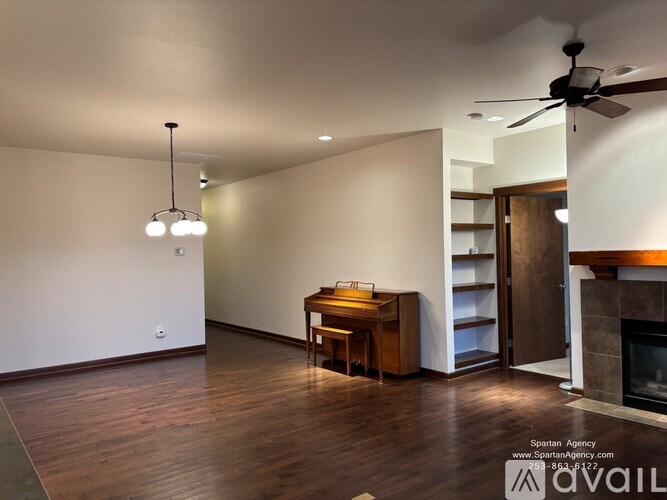 A modern living room with a wooden floor and a fireplace.