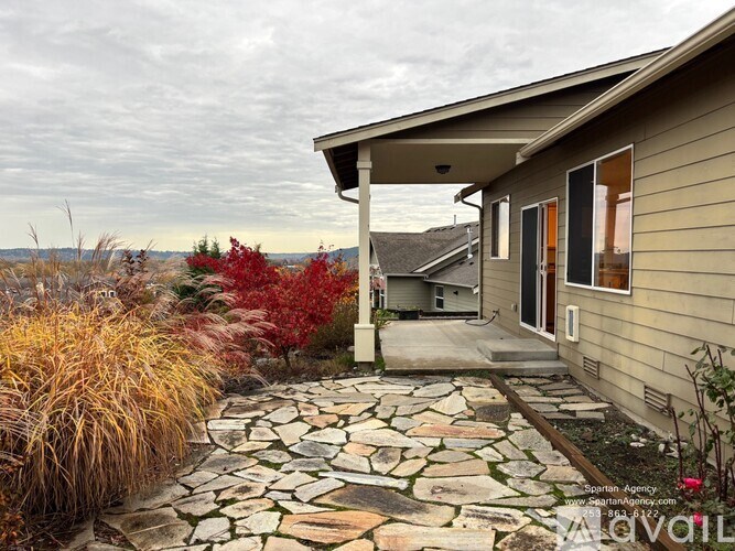 A house with a stone pathway leading to the front door.